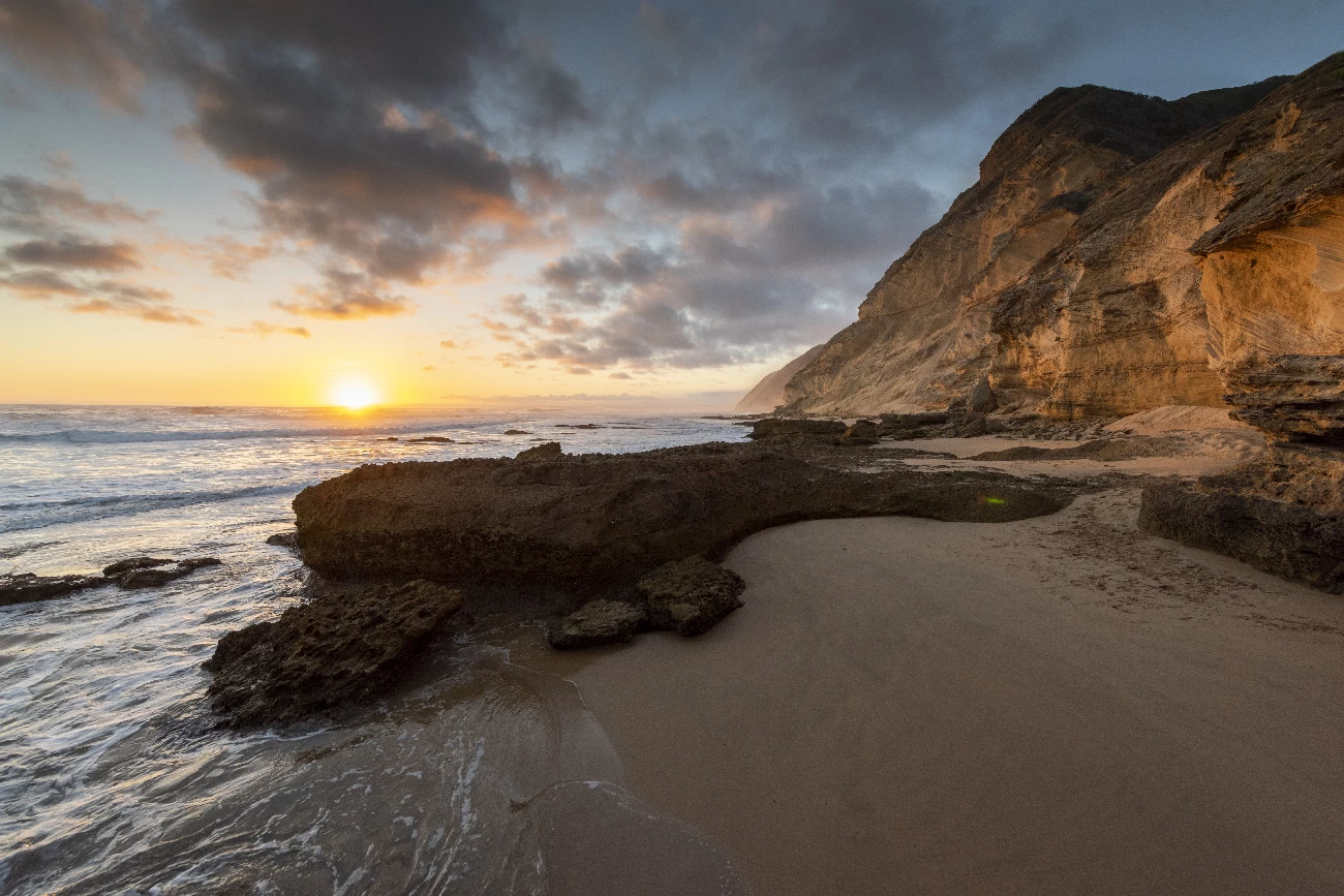beach with sun and rock