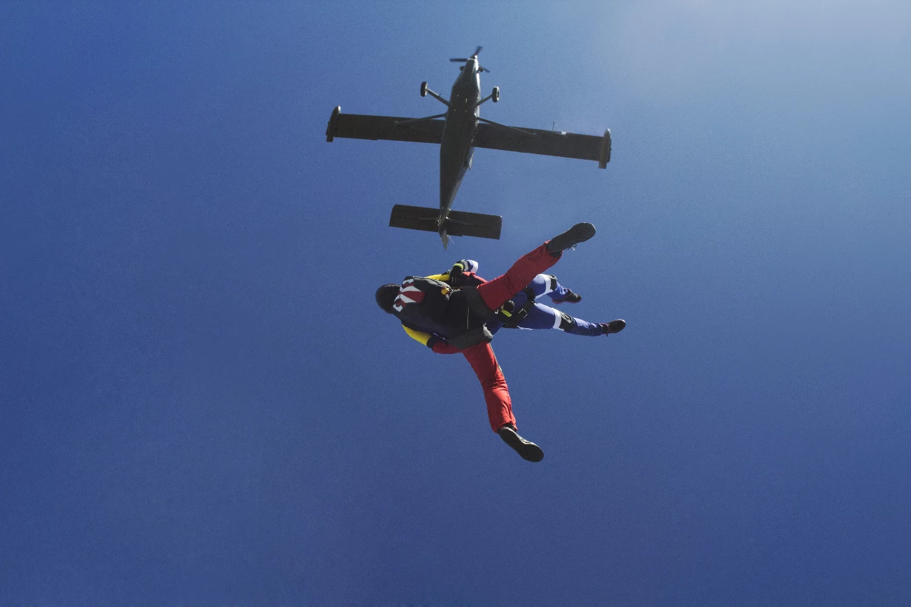 men jumping out of plane