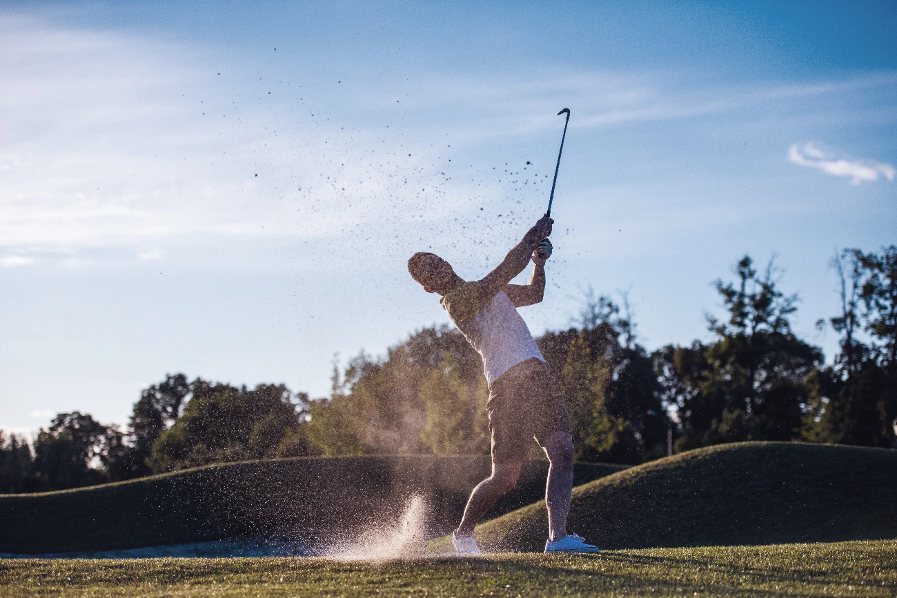 guy swinging golf club